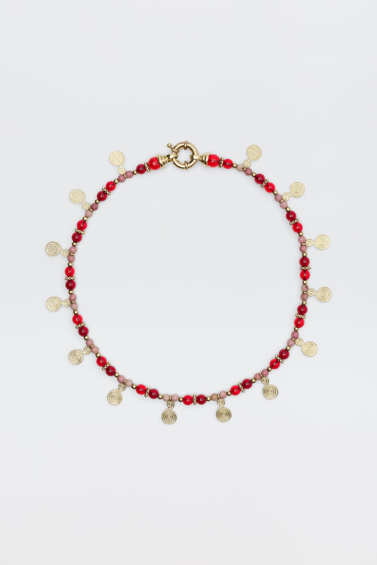 The Tala - Burgundy necklace features alternating red and pink beads with small gold spiral charms hanging evenly, shown on a white background.