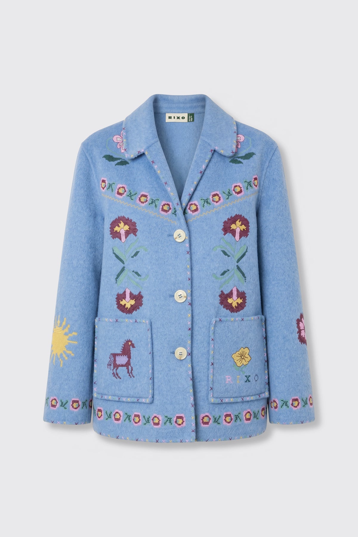 Tashia - Juliette Embroidery Blue: Light blue wool jacket featuring floral embroidery with sun and horse motifs, button front closure, two pockets, decorative stitching, and a visible RIXO brand label at the collar.