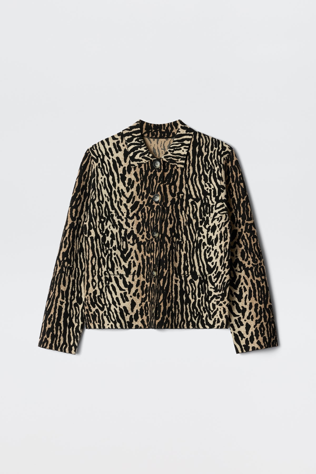 The Trista - Bohemia Leopard Brown is a long-sleeve jacket featuring a tan and black animal print, button-up front, collar, and two chest pockets, shown against a white background.