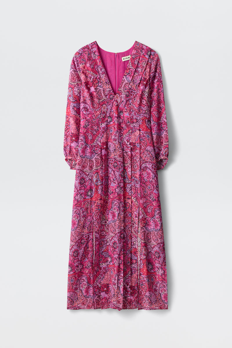 The Camellia - Paisley Floral Red is an ankle-length, long-sleeved dress featuring a vibrant pink and purple paisley pattern, V-neckline, and pleated skirt, shown on a plain white background.