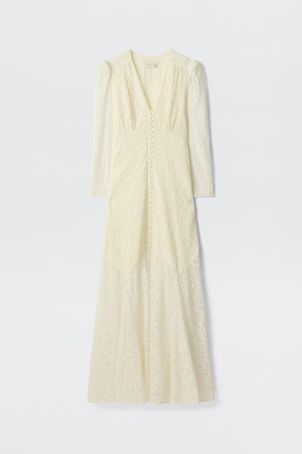 The Fleur - Ivory is a long-sleeved, floor-length ivory corded lace dress with a V-neckline, covered front buttons, and a subtle fit-and-flare silhouette, shown on a plain white background.