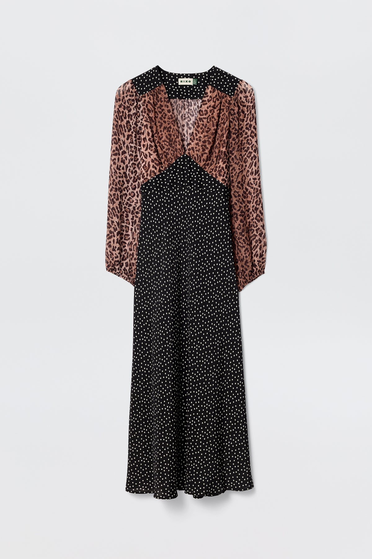 The Kaila - Leopard Spot Brown dress blends a brown and black leopard print top with a black polka dot midi skirt, featuring long sleeves, a V-neckline, and a slightly flared hem for a flattering silhouette.