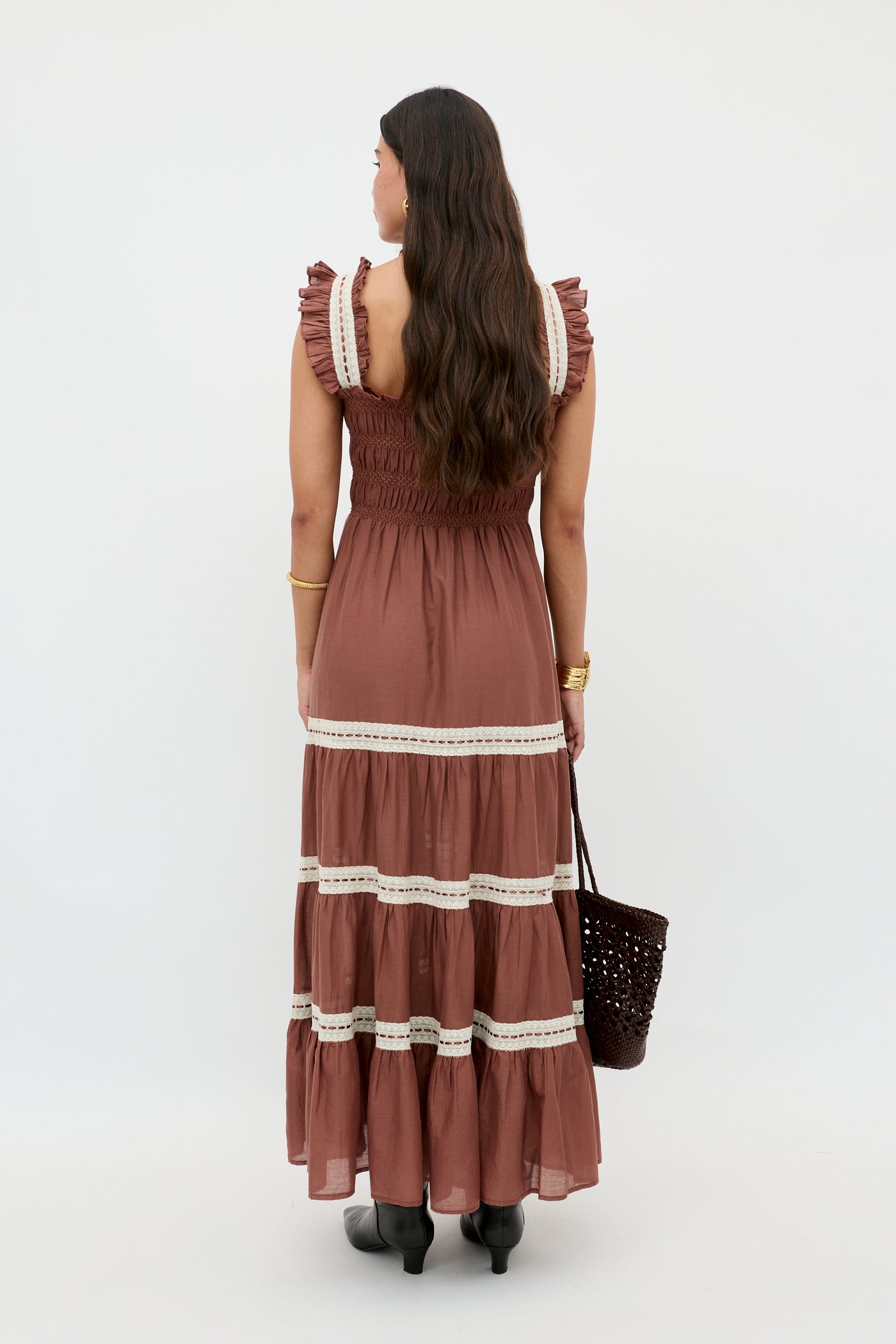 A woman in the Aubrie dress in brown.