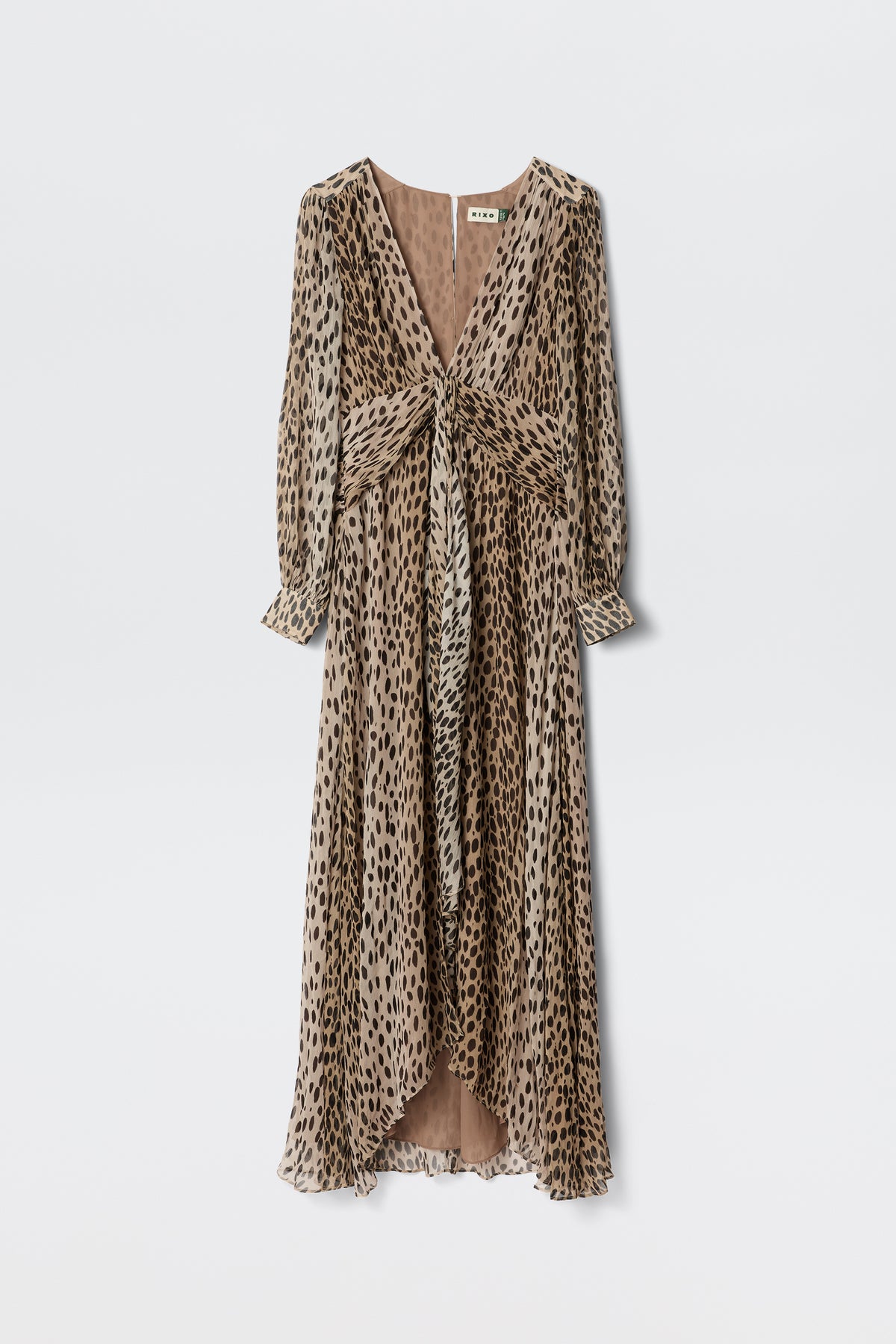 The Meera - Antelope Spot Black gown is a long, flowy dress with a deep V-neckline and long sleeves, crafted from crinkled-chiffon in a brown and black spot print. It features a gathered waist and chic knotted front detail.