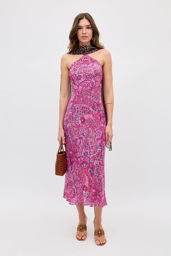 A woman faces forward wearing the Hayley - Leopard Paisley Mix Multi sleeveless midi dress, paired with a brown woven handbag, brown sandals, and a dark patterned scarf, set against a plain white background.