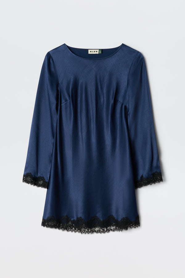 The Ridley - Midnight Navy is a long-sleeved satin dress with black lace trim at the cuffs and hem, shown on a plain white background.