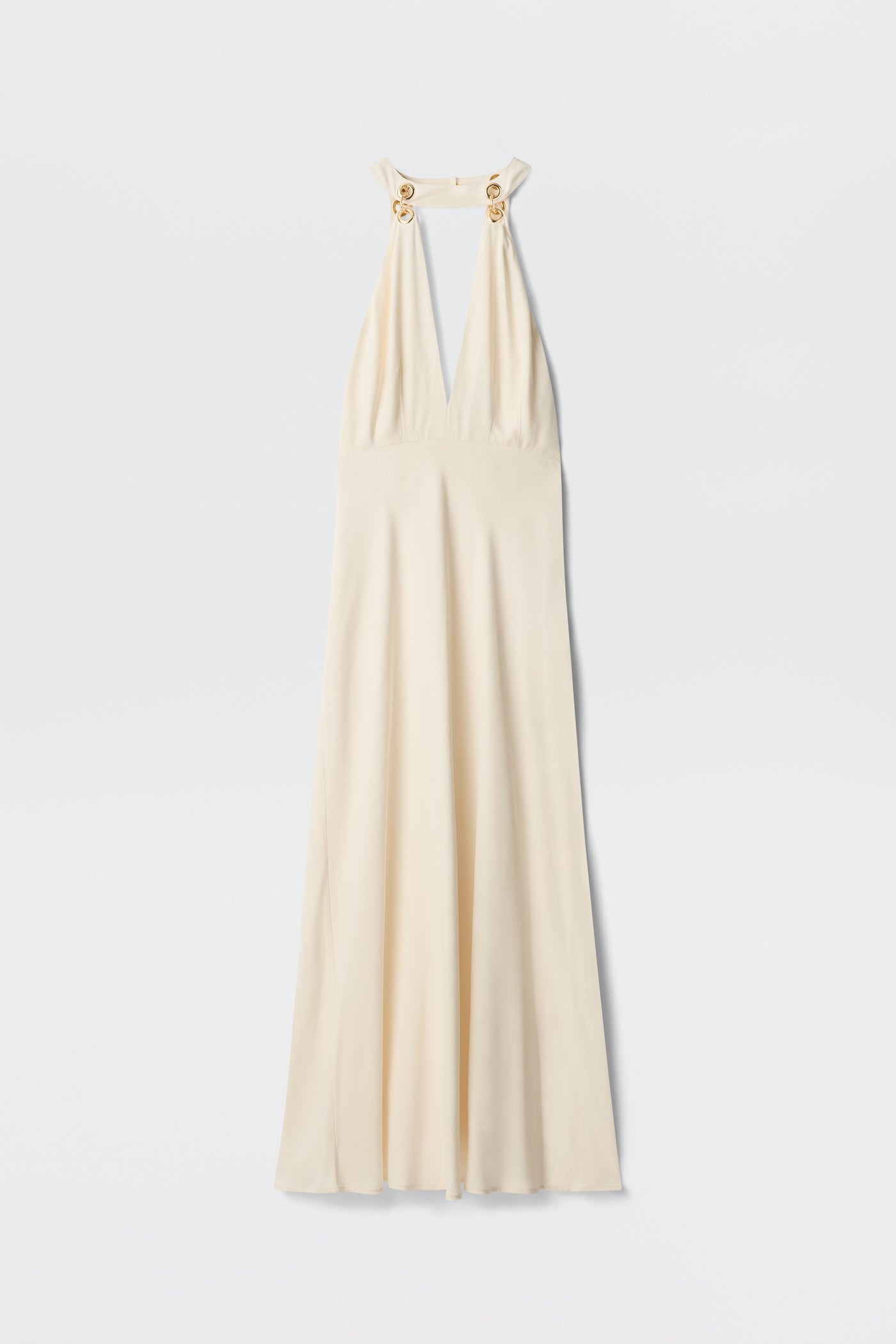 The Eleanora - Pearl dress is a vintage-inspired ivory, sleeveless floor-length gown with a deep V-neck, halter straps, gold ring accents on the shoulders, and a bias-cut hem, shown against a white background.