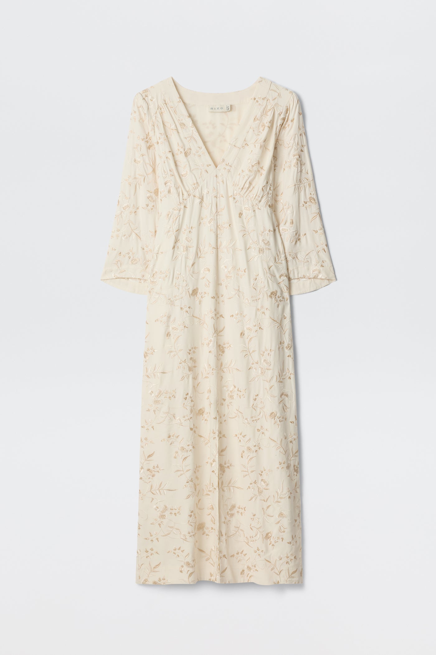 Dahlia - Botanical Embroidery Pearl: A long, cream-colored vintage-inspired dress featuring a subtle embroidered floral design, V-neckline, and long sleeves, displayed against a plain white background.