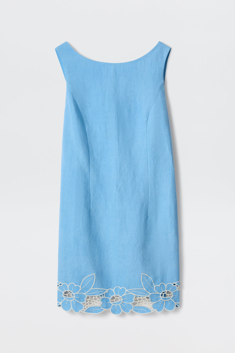 The Bingley - Daisy Cutwork Embroidery Blue is a sleeveless, knee-length women’s linen dress in light blue with a boat neckline and white floral embroidery along the hem—ideal for spring and summer.