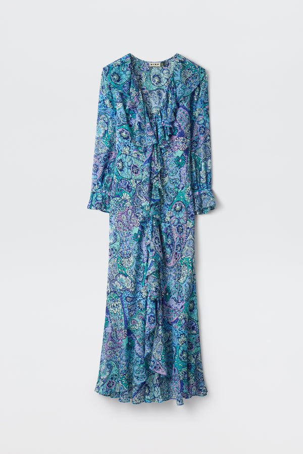 The Gracye - Paisley Floral Blue is a long-sleeved, ankle-length dress featuring a blue, green, and purple paisley print, ruffled front, V-neckline, and flared hem, shown against a plain white background.