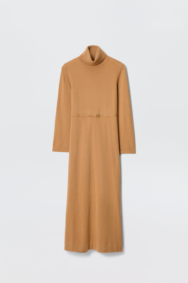 The Elliette - Camel is a long-sleeved turtleneck dress in camel, featuring a slim gold clasp belt at the waist for a minimalist style, shown against a plain white background.