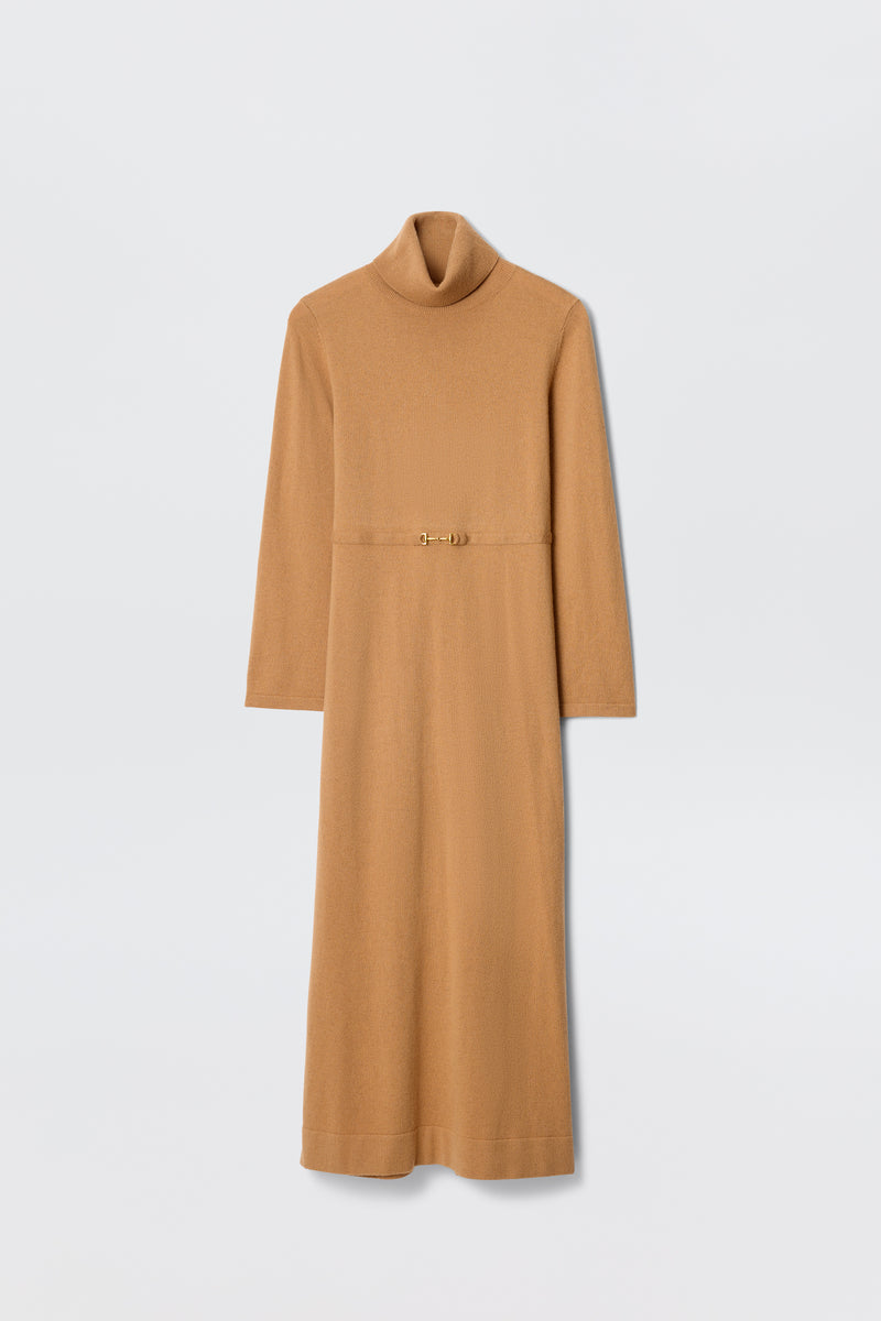 The Elliette - Camel is a long-sleeved turtleneck dress in camel, featuring a slim gold clasp belt at the waist for a minimalist style, shown against a plain white background.