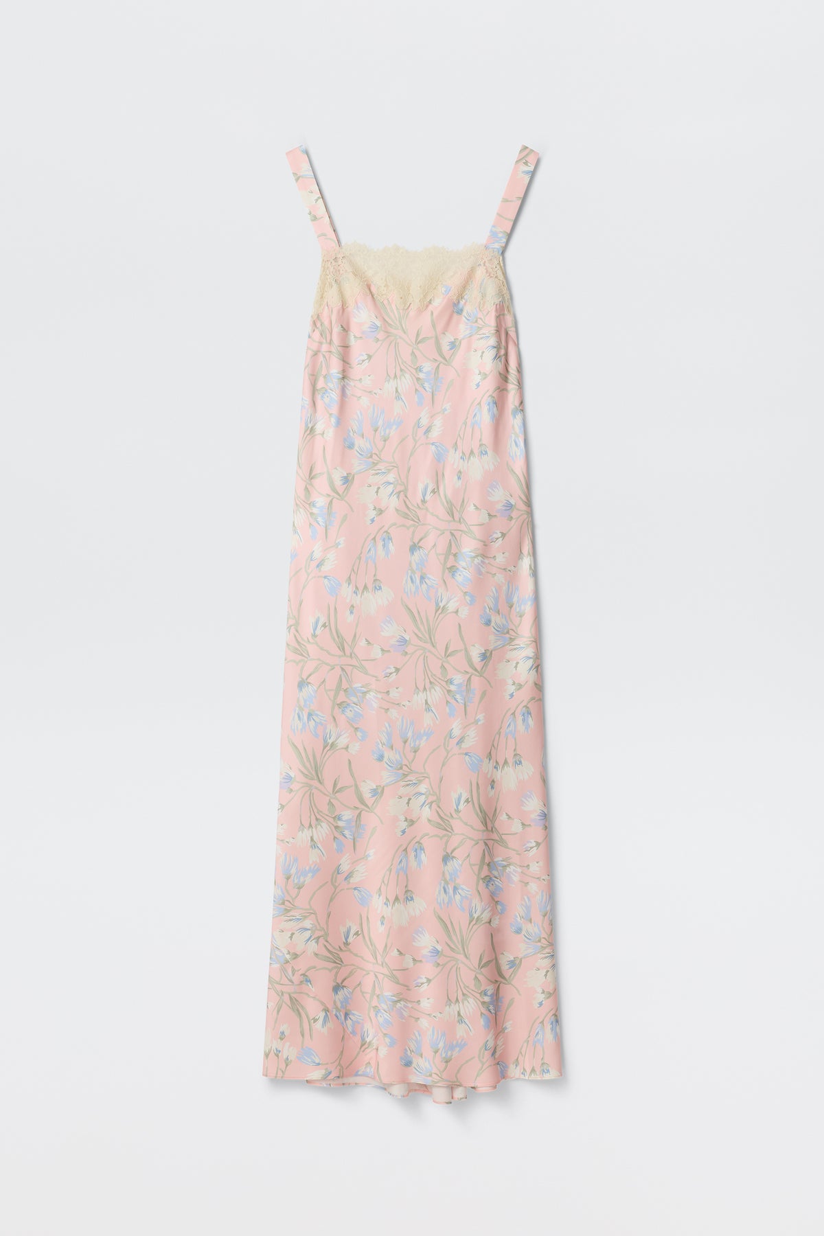 The Rosamarie - Watercolour Floral Pink is a long, sleeveless nightgown with thin straps, showcasing a light pink base with blue and white watercolor floral patterns and cream lace trim along the top.