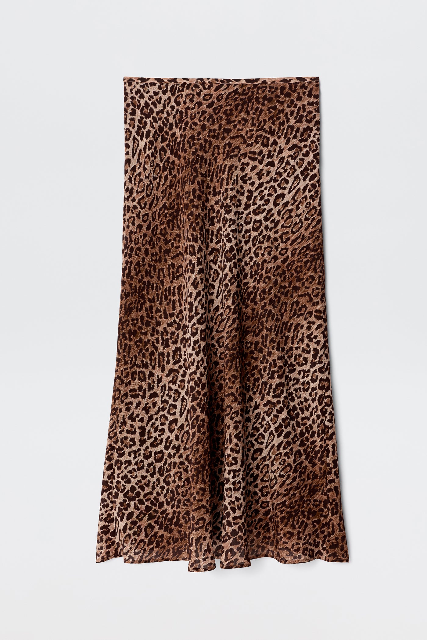 Kelly - Leopard Brown is a long, flared skirt crafted from luxurious silk crepe de chine, showcasing a striking brown and black leopard print pattern and displayed flat against a white background.