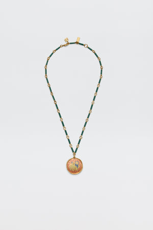 The Ari - Astro Leo necklace features gold and green beads with a circular pendant showcasing a vibrant, intricate design; displayed on a plain white background, this striking zodiac piece brings personality and charm to any look.