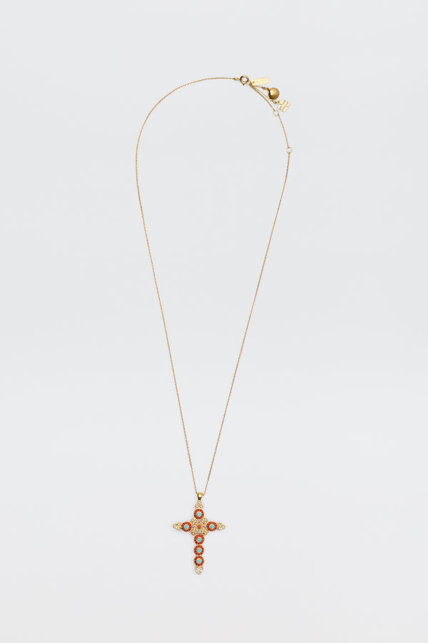 The Lenka - Gold necklace features a gold chain with a cross pendant embellished with red and clear stones, shown against a plain white background.