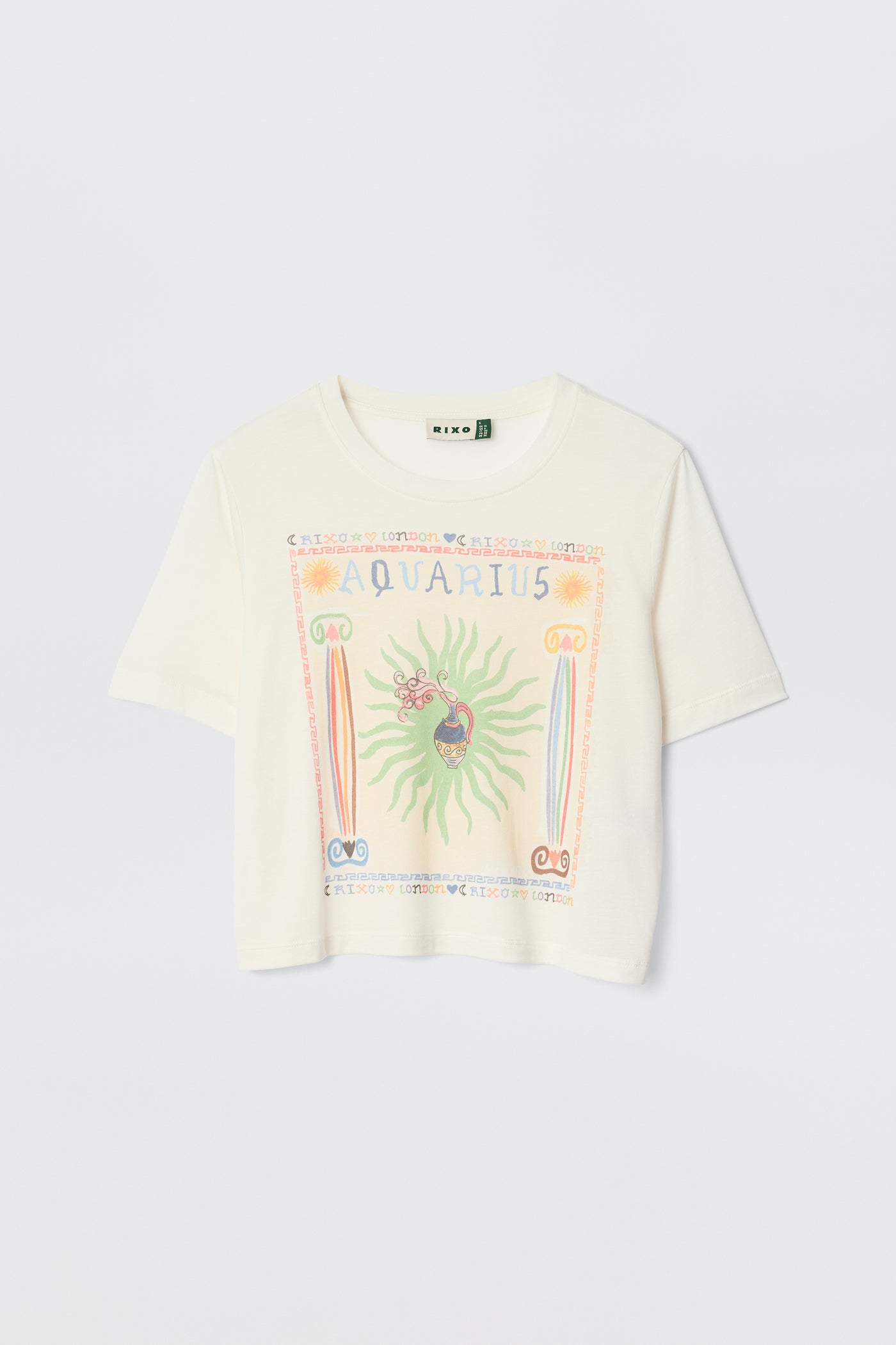 The Ria - Aquarius is a white short-sleeve tee with a vibrant Aquarius illustration, symbols, and a sunburst design—styled on a plain light background and perfect to pair with RIXO skirts for a chic look.