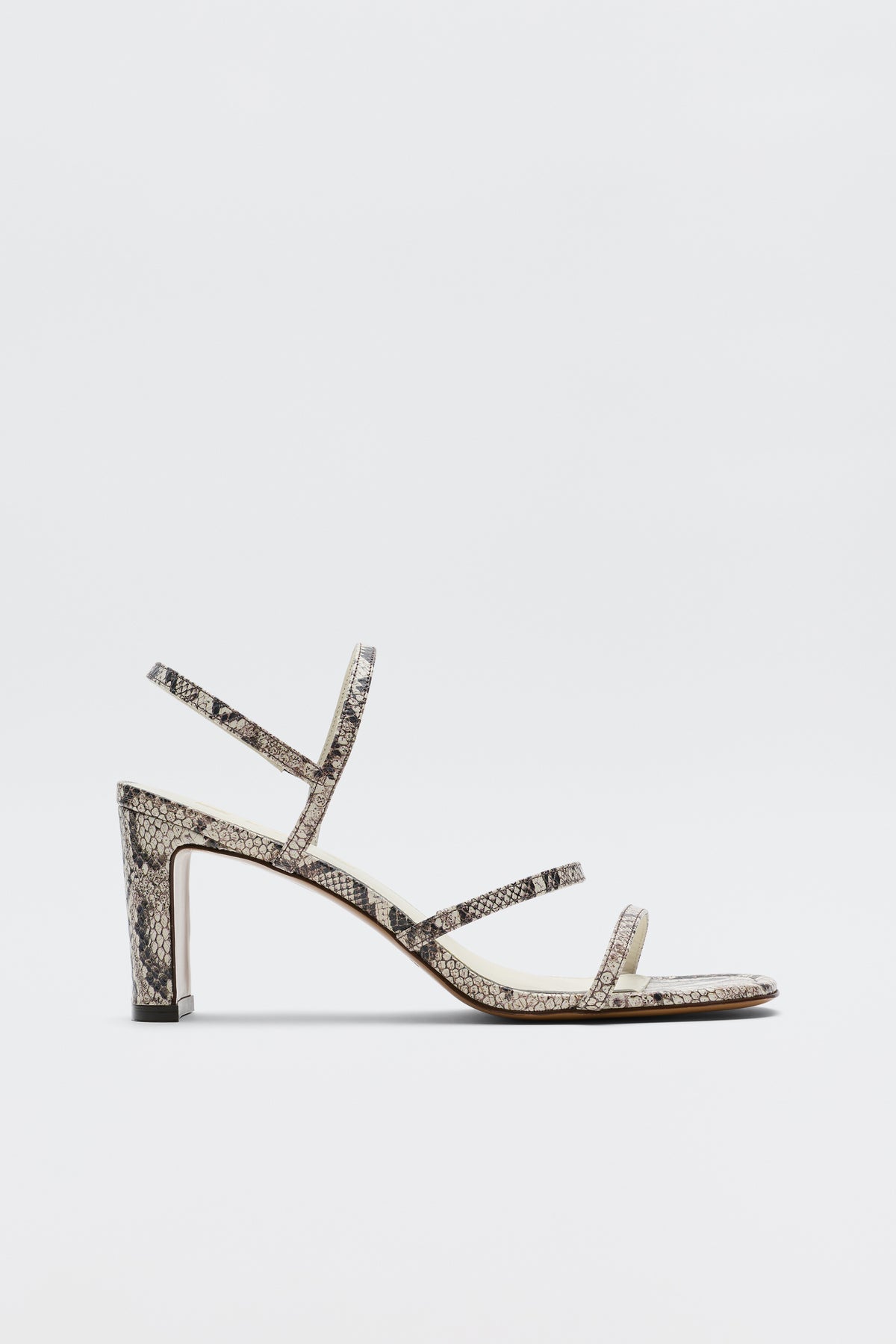 The Ciervo - Snakeskin is a high-heeled strappy leather sandal with an eye-catching snakeskin print, designed with three slim straps over the foot and a sturdy block heel. Shown against a plain white background, it’s the perfect finishing touch for your favorite RIXO occasion wear.