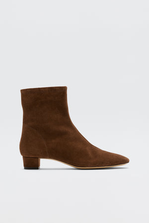 Rey - Chocolate: Feminine brown suede ankle boots with a low block heel and slightly pointed toe, shown on a plain white background.