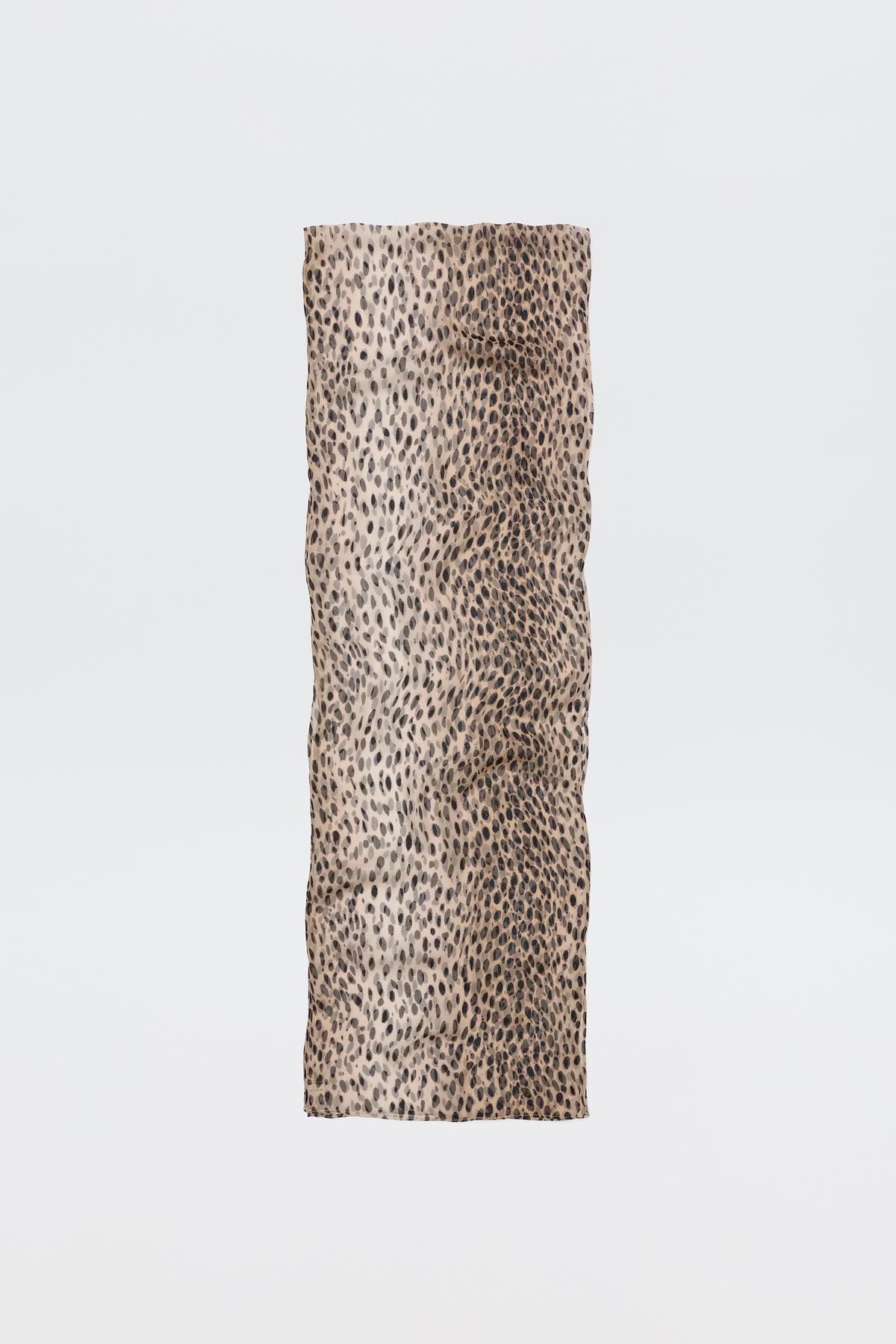 The Julien Scarf Antelope Spot Black features a rectangular crinkled-georgette fabric with a beige base and black irregular antelope spots, shown on a plain white background—perfect for expressing your wild side.