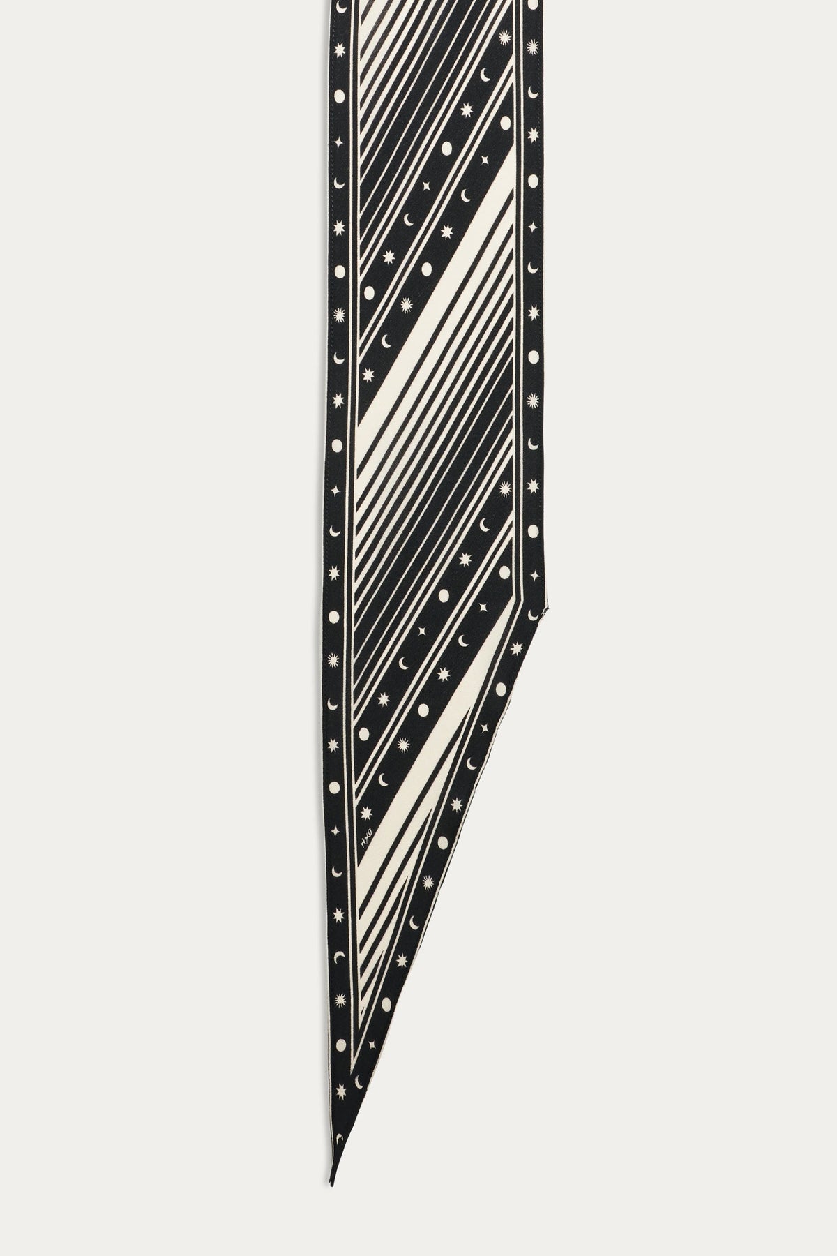 The Yelina - Starstruck Black scarf features a bold graphic print with diagonal stripes, dots, and star and crescent moon patterns along the edges, finished with a pointed tip.