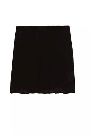 The Mini Slip Skirt - Black is a straight-cut, slightly flared black mini skirt, ideal for layering under dresses or pairing with slip tops. Displayed on a white background.