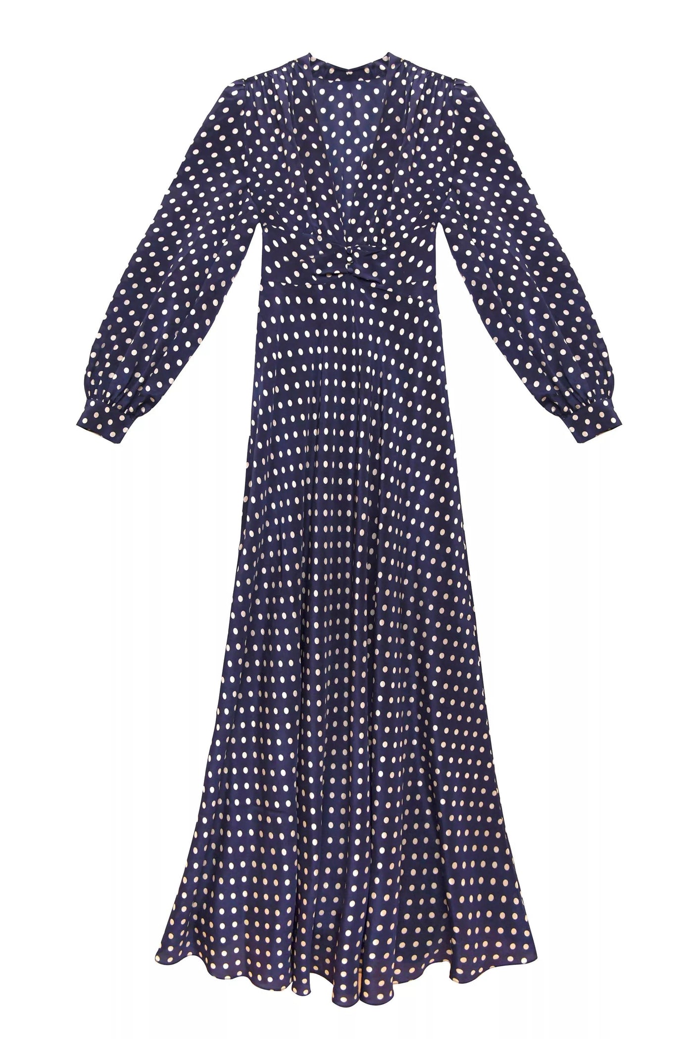 The Emory - Runway Spot Navy is a long-sleeved, floor-length dress with a fitted waist, featuring classic white polka dots on a navy background.