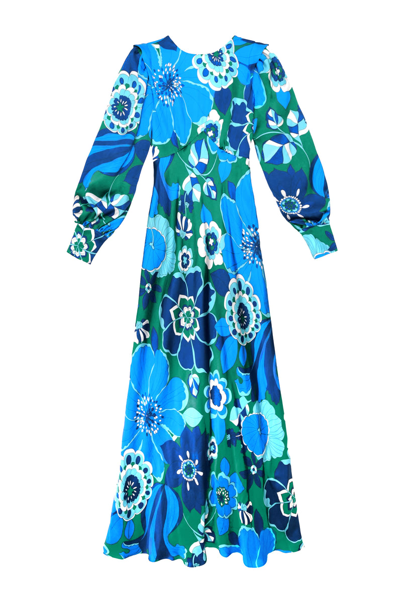 The marni - miami floral emerald is a long-sleeved, floor-length gown with a fitted waist, blouson sleeves, and a flowing skirt, adorned in vibrant blue, green, and white floral patterns for an elegant look.