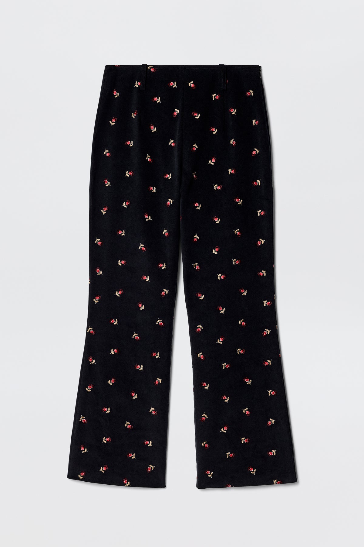 Olwen - Dandy Embroidery Deep Navy fit and flare trousers in black velvet, straight leg, with small red and green embroidered flowers. Vintage-inspired tailoring style shown laid flat on a light gray background.