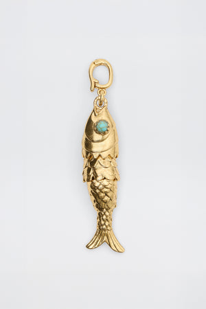 Nerissa - Gold: Fish-shaped pendant featuring detailed scales, a turquoise-colored eye stone, and a small top clasp for attaching to a chain, displayed on a plain white background.