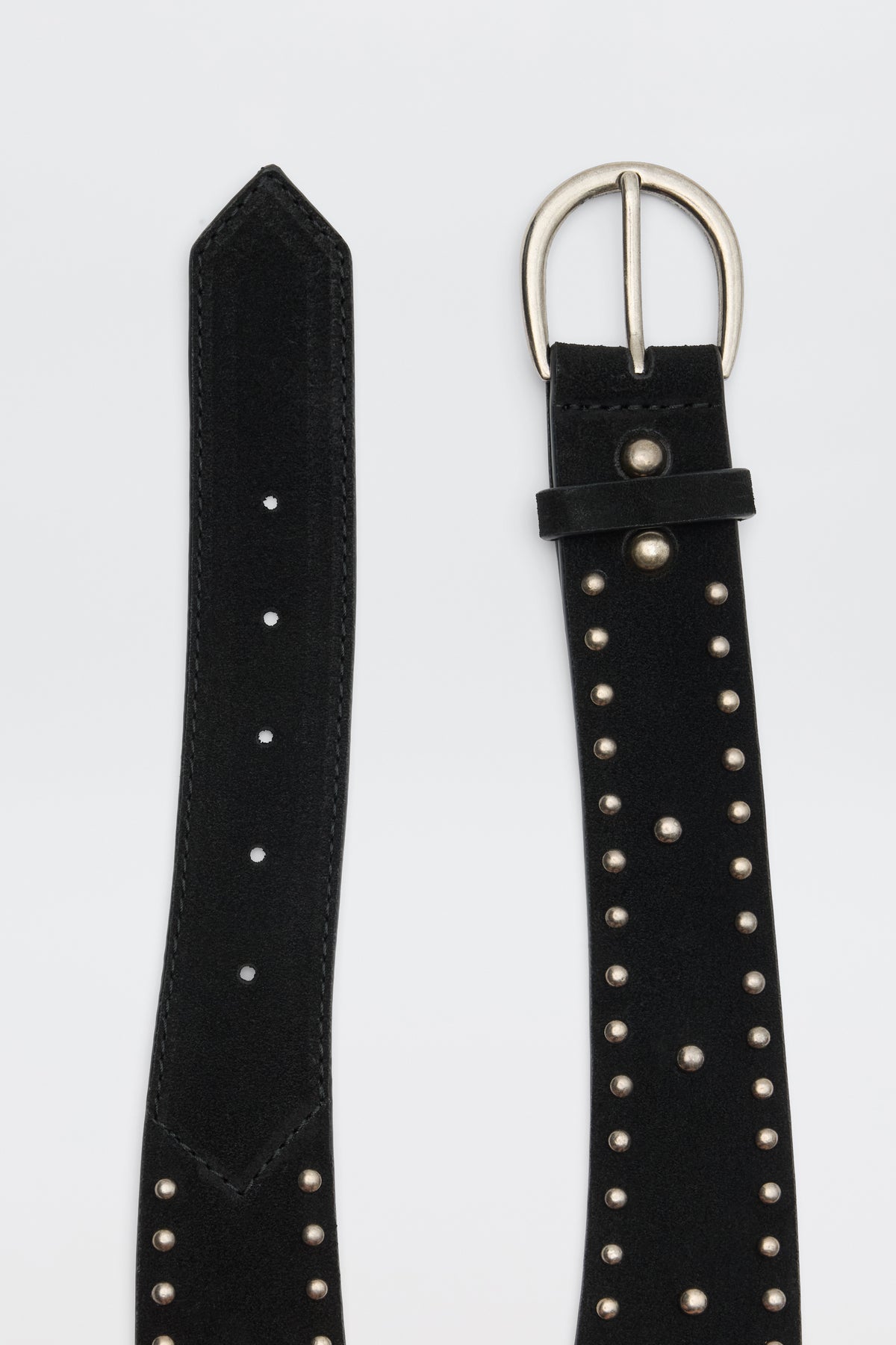 Lorelei - Black suede belt featuring silver studs, multiple holes, and a silver buckle, shown with both the buckle end and pointed tip visible against a plain background.